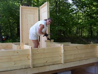 Customer building a cabin kit made by bavarianocottages.com